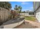 A side yard features a boat on a brick paved surface, and bordered with wood and vinyl fences at 991 Narcissus Ave, Clearwater Beach, FL 33767