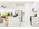 Modern kitchen with white cabinets, stainless steel appliances, and island seating at 10212 Gentle Rain Dr, Land O Lakes, FL 34638