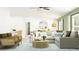 Bright living room with ample seating, stylish decor, and an open floor plan great for entertaining at 10212 Gentle Rain Dr, Land O Lakes, FL 34638