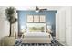 Serene main bedroom with blue accent wall, stylish decor, and ample natural light at 10212 Gentle Rain Dr, Land O Lakes, FL 34638