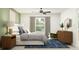 Stylish bedroom with a plush bed, a sleek dresser, modern decor, and a cozy accent chair at 10212 Gentle Rain Dr, Land O Lakes, FL 34638
