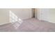 Bright bedroom with a large window, neutral walls, soft carpet, and an open doorway at 10800 Tarflower Dr # 202, Venice, FL 34293