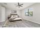 Stylishly furnished bedroom with a large window and ceiling fan at 10800 Tarflower Dr # 202, Venice, FL 34293