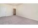 Bright bedroom with a large window, neutral walls, soft carpet, and an open doorway at 10800 Tarflower Dr # 202, Venice, FL 34293