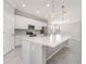 Bright kitchen with an oversized island, stainless appliances, and stylish pendant lighting at 10800 Tarflower Dr # 202, Venice, FL 34293