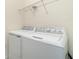 Bright laundry room featuring a full-size washer and dryer at 10800 Tarflower Dr # 202, Venice, FL 34293