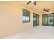 Spacious covered patio with ceiling fans and sliding glass doors at 10800 Tarflower Dr # 202, Venice, FL 34293