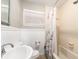 Well-lit bathroom with a combined tub and shower and a decorative shower curtain at 1108 Commodore St, Clearwater, FL 33755