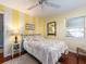 Bright bedroom with charming decor, including a ceiling fan and yellow striped accent wall at 1108 Commodore St, Clearwater, FL 33755