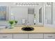 Bathroom vanity featuring a black sink, ample countertop space, and a large mirror with vanity lighting at 1213 Halifax Ct, Tarpon Springs, FL 34688