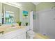 Bright bathroom with shower, complemented by fresh decor and ample counter space at 1213 Halifax Ct, Tarpon Springs, FL 34688
