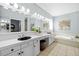 Bathroom featuring double vanity, tub and neutral decor at 1213 Halifax Ct, Tarpon Springs, FL 34688