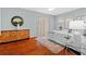 Well-lit bedroom features light walls, wood floors, and decor at 1213 Halifax Ct, Tarpon Springs, FL 34688