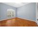 Relaxing bedroom with hardwood floors, large window, and ample natural light at 1213 Halifax Ct, Tarpon Springs, FL 34688