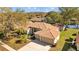 Charming single story home with a terracotta roof, two car garage, and lush landscaping at 1213 Halifax Ct, Tarpon Springs, FL 34688