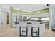 Modern kitchen with white cabinetry, stainless steel appliances, and a cozy breakfast bar seating area at 1213 Halifax Ct, Tarpon Springs, FL 34688