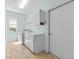 Well-lit laundry room with modern washer, dryer, and ample storage cabinets above the sink at 1213 Halifax Ct, Tarpon Springs, FL 34688