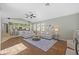 Spacious open living room with hardwood floors and bright kitchen in the background at 1213 Halifax Ct, Tarpon Springs, FL 34688
