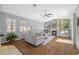 Bright living room with hardwood floors, fireplace, and large windows at 1213 Halifax Ct, Tarpon Springs, FL 34688