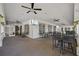 Covered patio with multiple ceiling fans and wall mounted TVs with tables and chairs at 1213 Halifax Ct, Tarpon Springs, FL 34688
