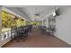 Covered porch area for relaxing with tables and chairs and outdoor views at 1213 Halifax Ct, Tarpon Springs, FL 34688