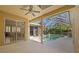 Covered pool patio with screened enclosure and dining area view at 1213 Halifax Ct, Tarpon Springs, FL 34688