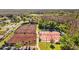 Aerial view of several tennis courts with players on the courts at 1213 Halifax Ct, Tarpon Springs, FL 34688