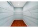 Walk-in closet with wire shelving and hardwood flooring at 1213 Halifax Ct, Tarpon Springs, FL 34688