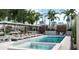 Resort-style pool area with lounge chairs, umbrellas, and lush landscaping in a modern setting at 126 4Th Ne Ave # 2201, St Petersburg, FL 33701