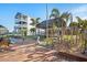 Scenic backyard with a tiki hut, tropical landscaping, and a wooden dock, perfect for outdoor relaxation and entertainment at 13429 Lisa Dr, Hudson, FL 34667