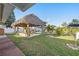 Thatched palapa with a dinette set and hammock, overlooking the backyard and boat dock at 13429 Lisa Dr, Hudson, FL 34667