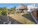 Backyard oasis featuring a tiki hut perfect for outdoor entertaining and relaxation, surrounded by lush landscaping at 13429 Lisa Dr, Hudson, FL 34667