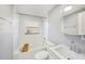 Well-lit bathroom features a tub and shower combo, a white vanity with a sink and chrome faucet, and a large mirror at 13429 Lisa Dr, Hudson, FL 34667