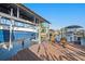 Modern boat lift on a private dock showcasing waterfront living and convenience for boat owners, with seating at 13429 Lisa Dr, Hudson, FL 34667
