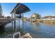 Waterfront property featuring a private boat dock with canopy, inviting relaxation and easy access to the water at 13429 Lisa Dr, Hudson, FL 34667