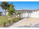 Cozy single-Gathering house with a manicured lawn and charming front porch with seating area at 13429 Lisa Dr, Hudson, FL 34667