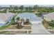 An aerial view showcases this well-maintained home with lush landscaping and a spacious three-car garage at 13941 Talmage Loop, Hudson, FL 34667