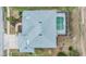 Birds eye view of roof, screened in pool and landscaping at 13941 Talmage Loop, Hudson, FL 34667