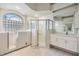 Bright bathroom with large window, walk-in shower, and walk-in bathtub at 13941 Talmage Loop, Hudson, FL 34667