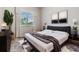 Cozy bedroom with large window, stylish artwork, and a comfortable bed with soft bedding at 13941 Talmage Loop, Hudson, FL 34667
