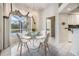 Bright breakfast nook features a glass table set, natural light, and a view of the outdoors at 13941 Talmage Loop, Hudson, FL 34667