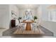 Bright dining room features modern table set, contemporary chandelier, and stylish decor at 13941 Talmage Loop, Hudson, FL 34667