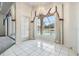 Bright dining room with tile floors, chandelier, and view of the outdoor pool at 13941 Talmage Loop, Hudson, FL 34667