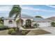 Well-maintained home with a three-car garage and mature landscaping at 13941 Talmage Loop, Hudson, FL 34667