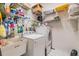 Organized laundry room with sink, washer, dryer, and shelving at 13941 Talmage Loop, Hudson, FL 34667