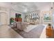 Spacious living room with tray ceiling, large windows, comfortable seating, and inviting ambiance at 13941 Talmage Loop, Hudson, FL 34667