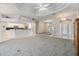 Open-concept living room with elegant tray ceilings and great natural light at 13941 Talmage Loop, Hudson, FL 34667