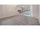 Open-concept living room featuring a pool view, tray ceilings and natural light at 13941 Talmage Loop, Hudson, FL 34667