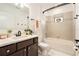 Well-lit bathroom featuring dark wood cabinets, a modern sink, and a bathtub with shower at 14330 Fissore Blvd, Wimauma, FL 33598