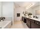 Bathroom featuring double vanity sinks, soaking tub and a walk-in shower at 14330 Fissore Blvd, Wimauma, FL 33598